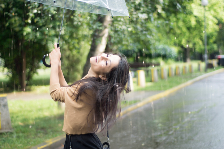 Young woman having fun in the rain
